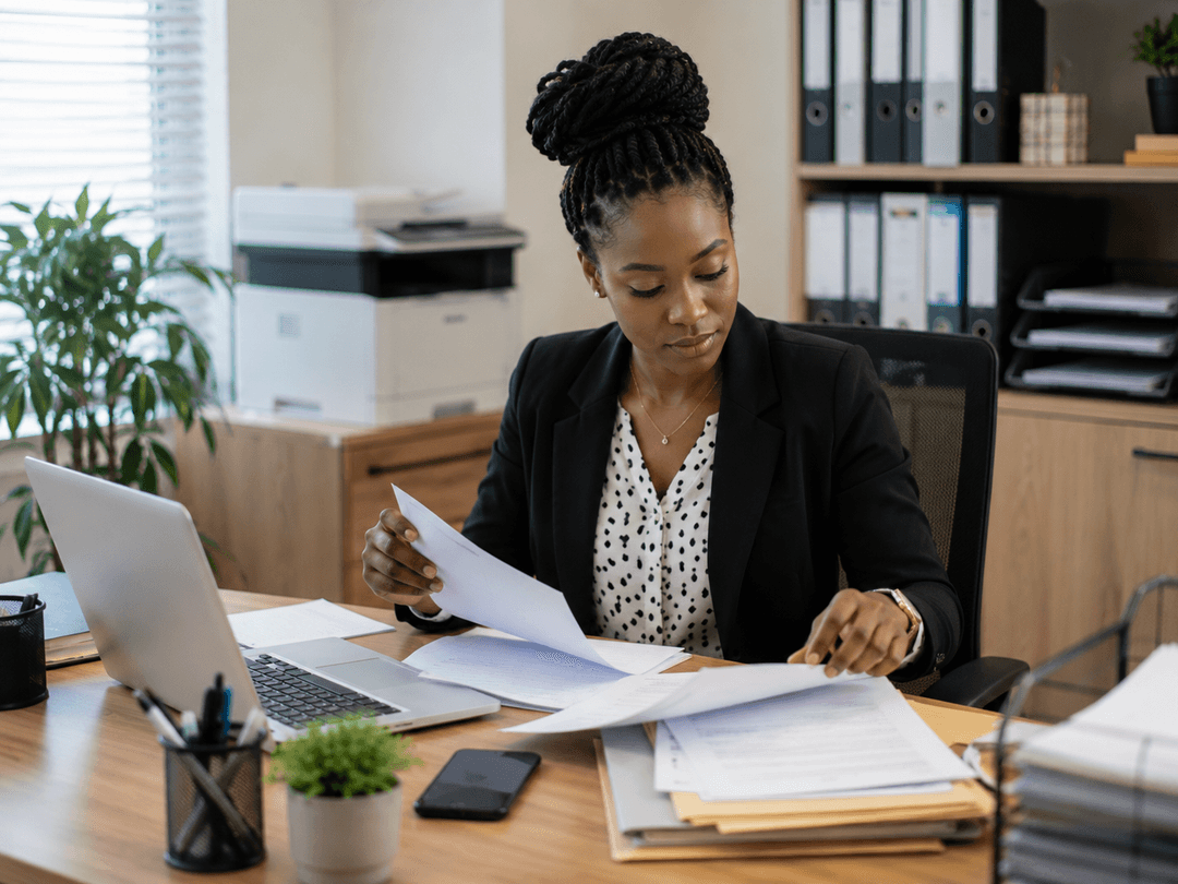 Secretary organizing documents in an office