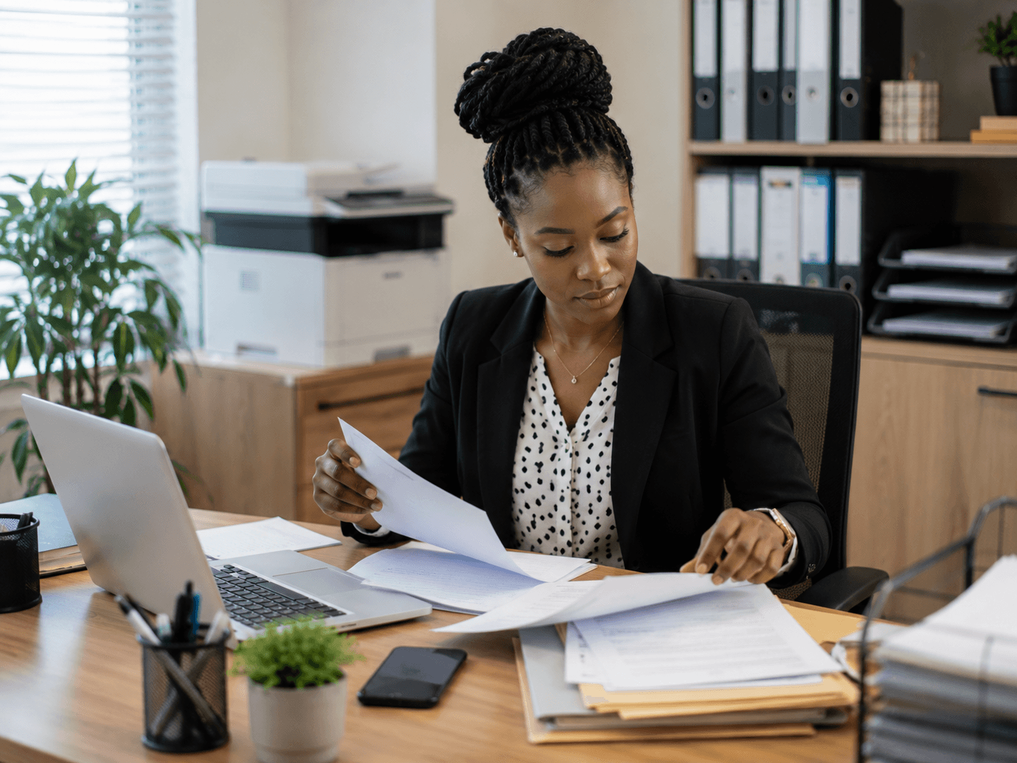 Secretary organizing documents in an office